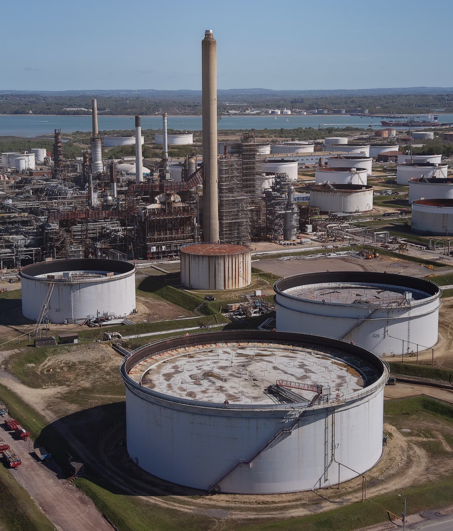 An oil refinery and its storage tanks beside the sea