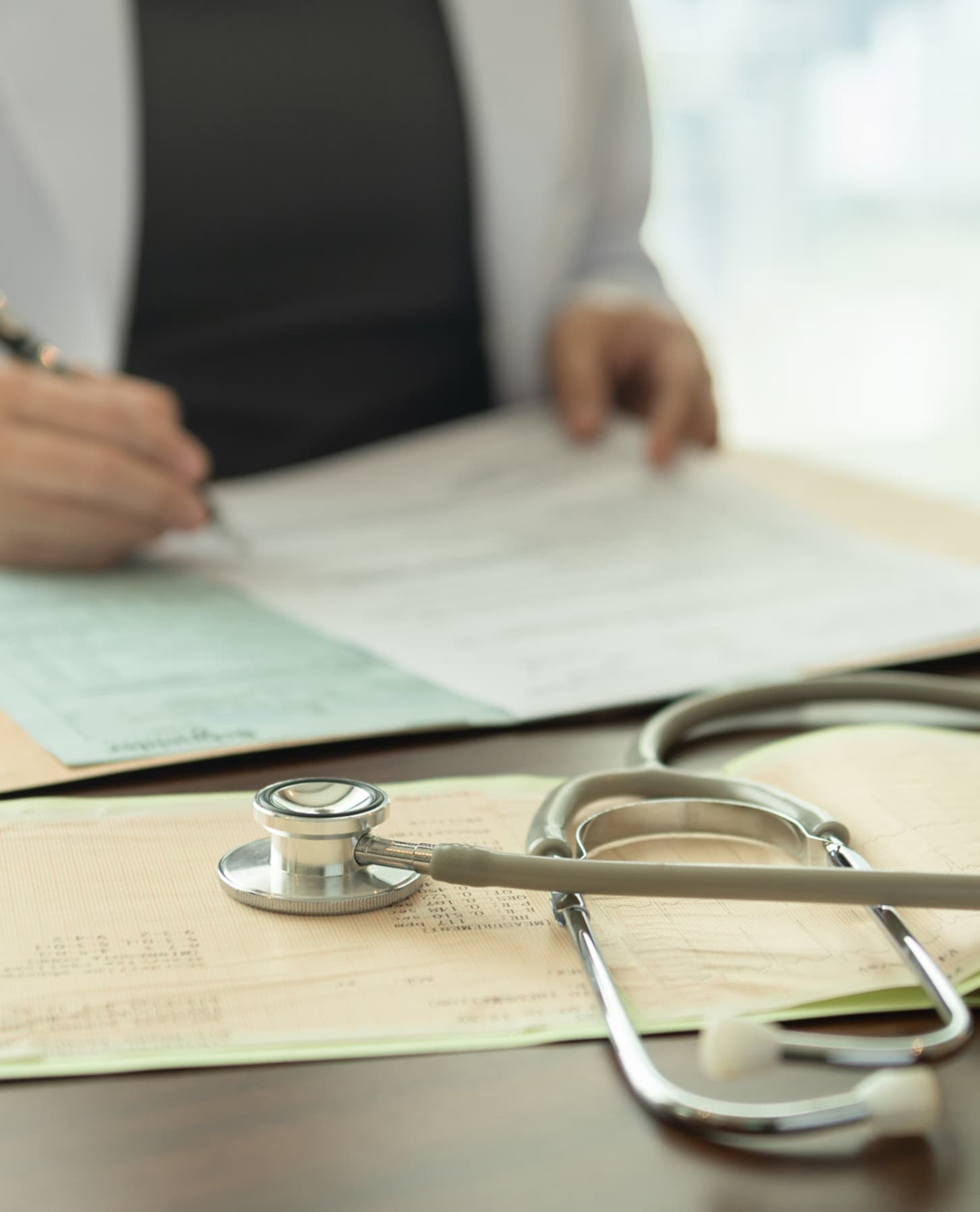 A doctor in a white coat holding a stethoscope