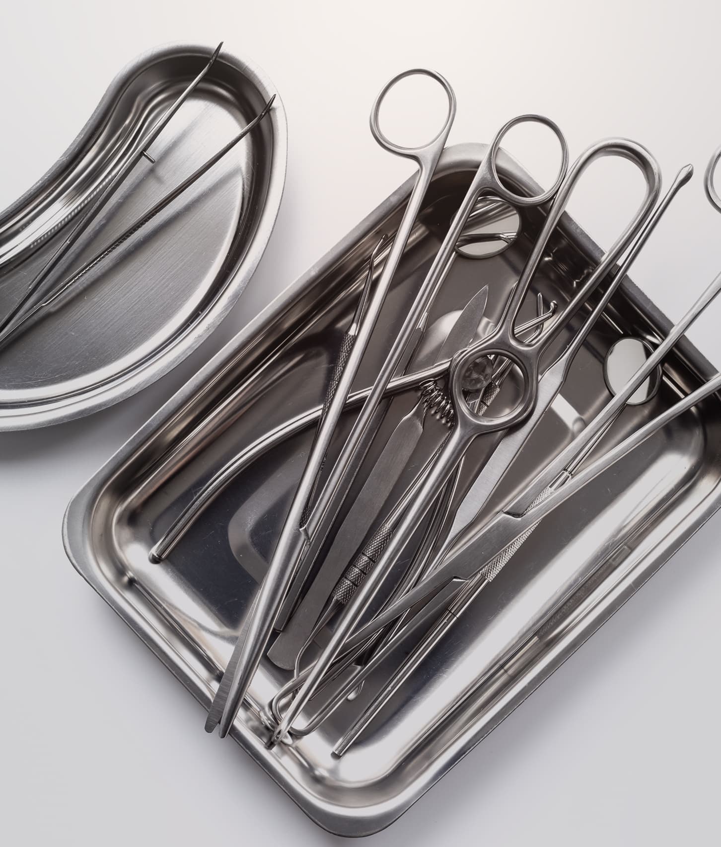 Steel surgical instruments laid out in a tray
