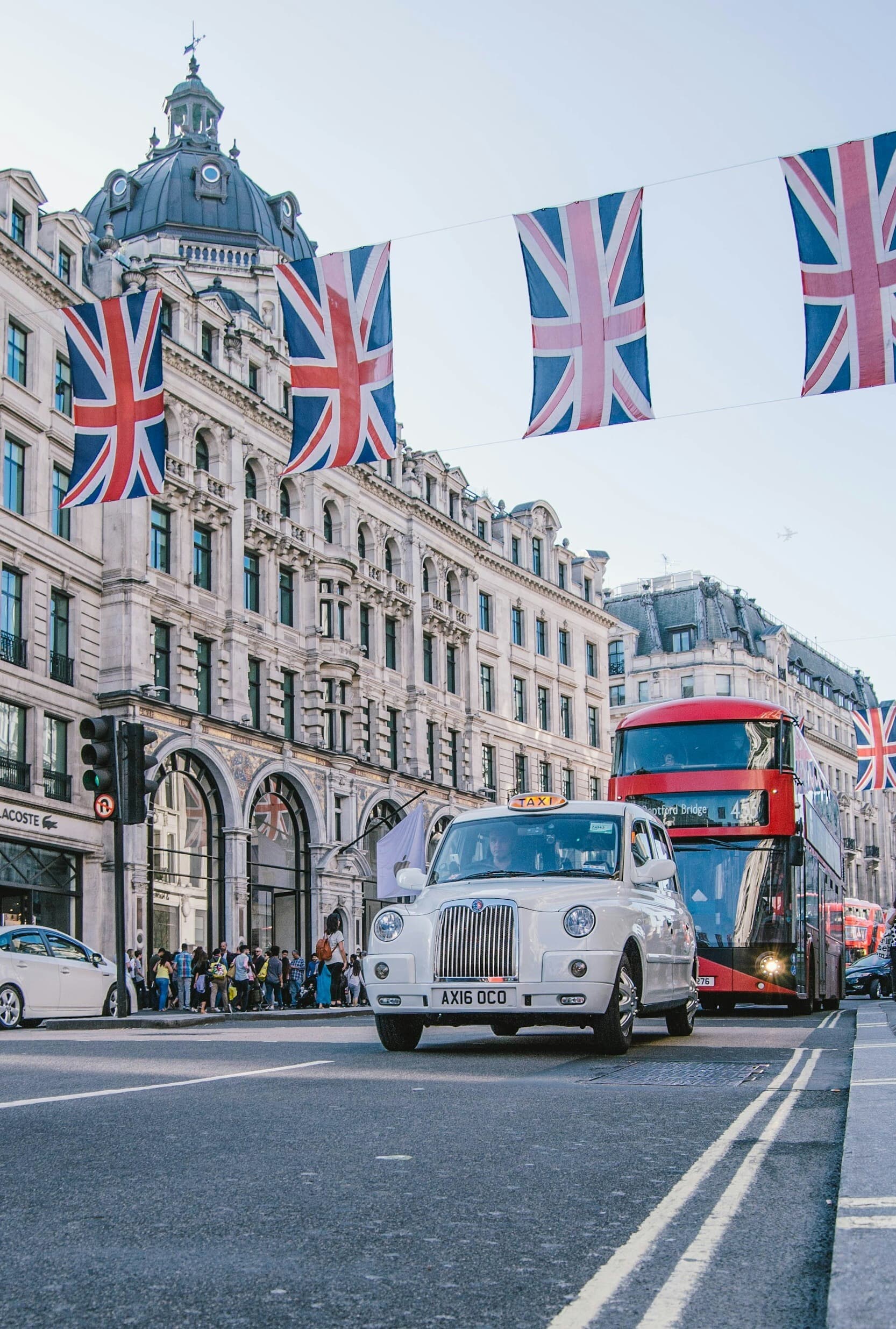 Regent Street, London, with Union flags and a black cab